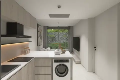 1 Bedroom Condo for Sale at Celine Wongamat modern kitchen with wood cabinets, white countertop, induction hob and washing machine