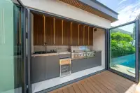5 Bedroom House for Sale in Bang Lamung outdoor kitchen with stainless steel BBQ grill, stone countertop and wine cooler