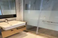 2 Bedroom Condo for Rent at Beverly Mountain Bay Pattaya bathroom with marble walls and glass shower