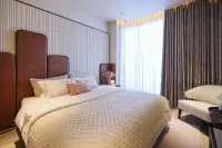 2 Bedroom Condo for Sale at Arom Jomtien second bedroom with leather headboard, quilted bedding and floor-to-ceiling curtains
