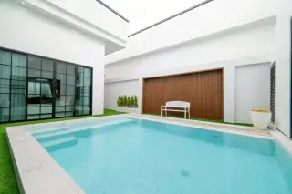 PCK Villa private pool with marble steps, white bench, wooden slat feature wall and glass-door access to interior