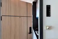 1 Bedroom Condo for Sale at The Twin Tower Jomtien Beach Pattaya wood-panel front door with smart lock and unit number 1342 signage