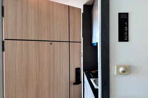 1 Bedroom Condo for Sale at The Twin Tower Jomtien Beach Pattaya wood-panel front door with smart lock and unit number 1342 signage