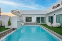 5 Bedroom House for Sale in Huai Yai large private pool with water slide and outdoor dining area at dusk