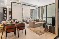 1 Bedroom Condo for Sale at Once Wong Amat: open-plan living and dining area with sofa, dining table, and bedroom beyond.