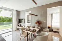 2 Bedroom Condo for Sale at The Coral Pattaya: elegant dining area with marble floor, leading to a bedroom and garden access.