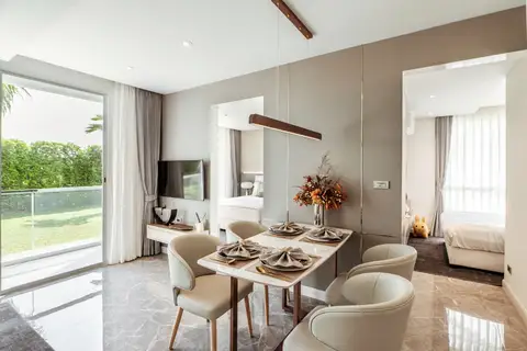 2 Bedroom Condo for Sale at The Coral Pattaya: elegant dining area with marble floor, leading to a bedroom and garden access.