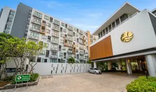 Stasia Dormy Residence street view of building facade, parking entrance, and landscaped driveway