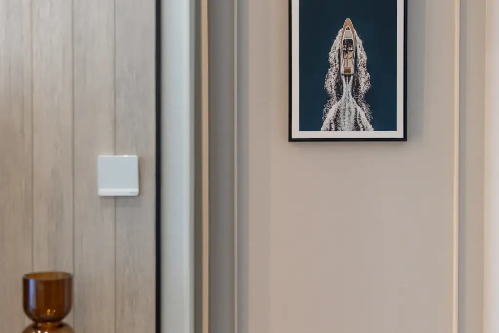 1 Bedroom Condo for Sale at Aquarous Jomtien Pattaya interior wall detail with framed aerial boat artwork and amber glass decor