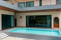 4 Bedroom House for Rent in Bang Lamung private pool with floor-to-ceiling sliding glass doors and upper balcony