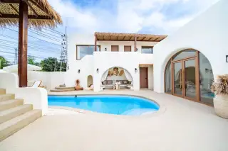 The Sunshine House private pool with arched cabana lounge and thatched roof exterior in Pattaya Thailand