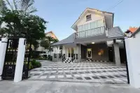 5 Bedroom House for Sale at Central Park 4. Front exterior of the house with a patterned driveway and ornate gate.