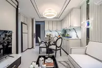 2 Bedroom Condo for Sale at Embassy Life, open-plan living room with white sofa, dining area, and modern kitchen.