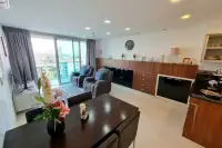 2 Bedroom Condo for Sale & Rent at Laguna Heights living room with recliners, dining table and balcony view