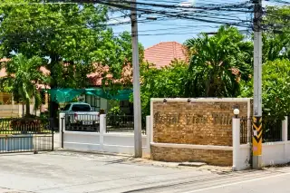 Royal View Village private swimming pool with blue tiles and white privacy wall.