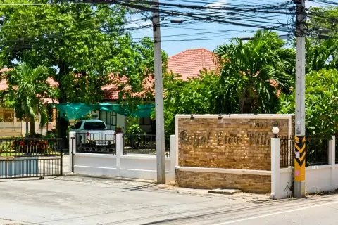 Royal View Village private swimming pool with blue tiles and white privacy wall.