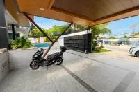 4 Bedroom House for Sale & Rent at M Mountain Village terrace walkway with potted plants beside pool area