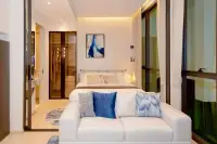 1 Bedroom Condo for Sale at Once Wong Amat bedroom with double bed, walk-in wardrobe, sofa, and floor-to-ceiling windows
