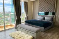 3 Bedroom Condo for Sale at Cetus Beachfront master bedroom with tufted headboard, king bed, and city view balcony