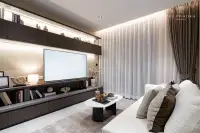 1 Bedroom Condo for Sale at Panora Estuaria: Open-plan living room with beige sofa, coffee table, and kitchen bar.
