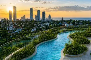 Love It Wongamat Beach rooftop winding pool at sunset overlooking Pattaya city skyline and Gulf of Thailand