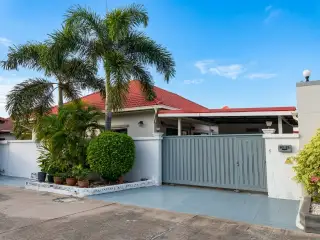 Siam Executive Estate street view of house exterior with palm trees and sliding gate