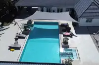 8 Bedroom House for Sale in Pong large rectangular swimming pool with sun loungers and shade sail from above