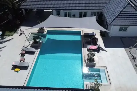 8 Bedroom House for Sale in Pong large rectangular swimming pool with sun loungers and shade sail from above