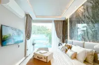 1 Bedroom Condo for Sale at The Riviera Santa Monica bedroom with large bed, marble accent wall, and pool view balcony.