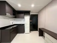 1 Bedroom Condo for Sale at The Ocean Pearl living area with sectional sofa and open kitchen