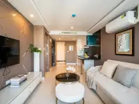 1 Bedroom Condo for Sale at Grand Avenue Residence living area with TV wall unit and view into kitchen