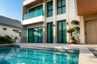 5 Bedroom House for Sale at Impress House Village outdoor swimming pool with marble deck and glass-balcony exterior