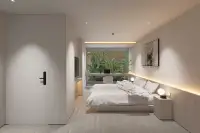 2 Bedroom Condo for Sale at Celine Wongamat minimalist bedroom with LED cove lighting, platform bed, and garden view window