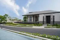 4 Bedroom House for Sale at Cascade side exterior view with lush landscaped garden, private lap pool, and open covered terrace