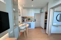1 Bedroom Condo for Sale at The Twin Tower Jomtien Beach Pattaya compact kitchen with light grey cabinets and dining table for two