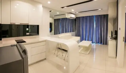 1 Bedroom Condo for Sale at City Center Residence white kitchenette and lounge area with blue curtains at dusk