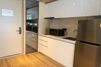 1 Bedroom Condo for Rent at Beverly Mountain Bay Pattaya modern kitchen with marble backsplash, sink, and stainless fridge