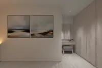 2 Bedroom Condo for Sale at Celine Wongamat walk-in wardrobe area with wood cabinets, vanity dressing table, and abstract wall art