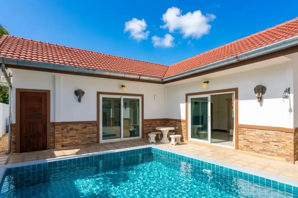 2 Bedroom House for Rent private swimming pool in a courtyard with white walls and red tiled roof under blue sky.
