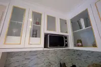 2 Bedroom Condo for Sale at Seven Seas Le Carnival kitchen countertop with electric stove, sink, and tiled backsplash.