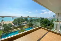 2 Bedroom Condo for Rent at Cetus Beachfront wide glass-railed balcony overlooking pool, palm trees, and Pattaya beachfront sea view