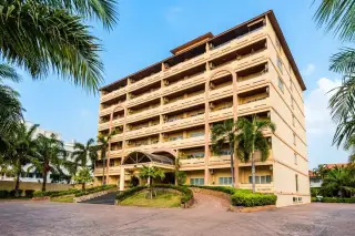 View Talay Residence 1&2 full condo building exterior with arched facade, balconies, and palm-lined driveway