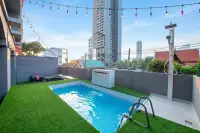 10 Bedroom House for Sale in Bang Lamung private swimming pool with artificial grass lawn, outdoor shower, and city skyline view
