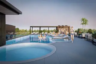 Siam Oriental Beach rooftop swimming pool with a hot tub, lounge chairs, and people relaxing under a clear sky.