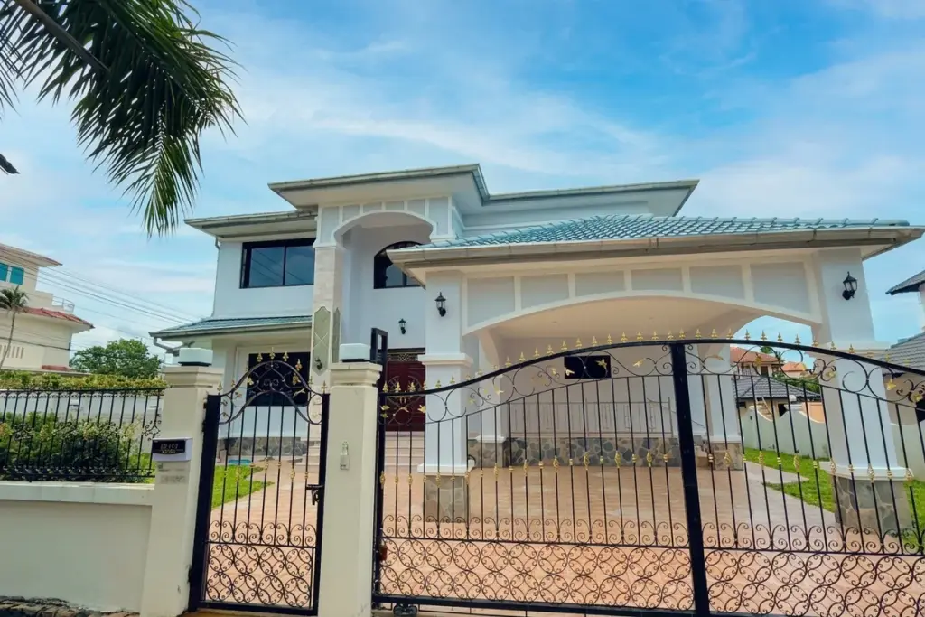 4 Bedroom House for Sale at Paradise Villa 1 & 2 white two-storey exterior with ornate black and gold iron gate