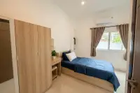 3 Bedroom House for Sale at The Flow Pong - Mabprachan bright living room with tray ceiling, cove lighting, wood panel wall and garden views