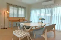 3 Bedroom House for Rent at Supalai Ville Pattaya - Motorway dining area with light wood table benches and sheer curtains