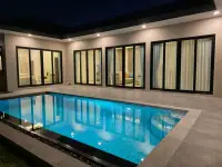 3 Bedroom House for Rent at Garden Ville 9 nighttime view of pool with glass doors and curtains