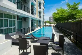 The Ocean Pearl exterior view of the multi-story condo building with balconies and large windows on a clear day.
