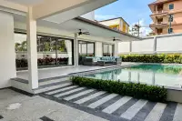 4 Bedroom House for Sale & Rent in Bang Lamung outdoor patio with private swimming pool, rattan seating and sliding glass doors